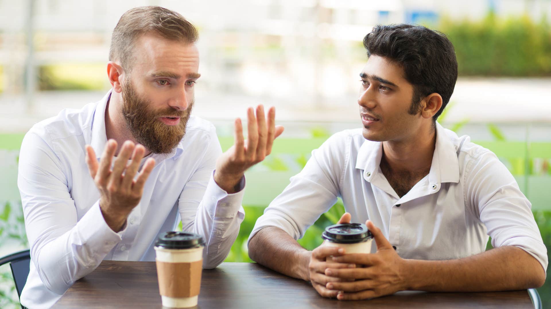 Man saying "I don't even argue anymore" to his friend.