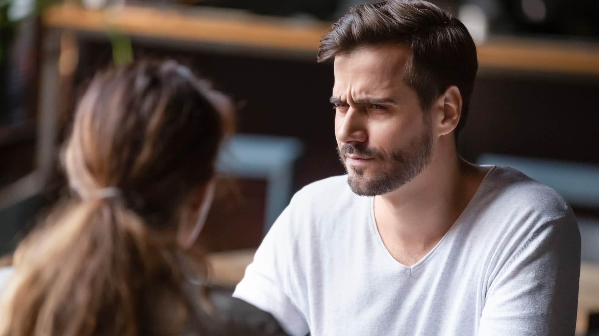Man saying "she just overreacts all the time" to a woman.