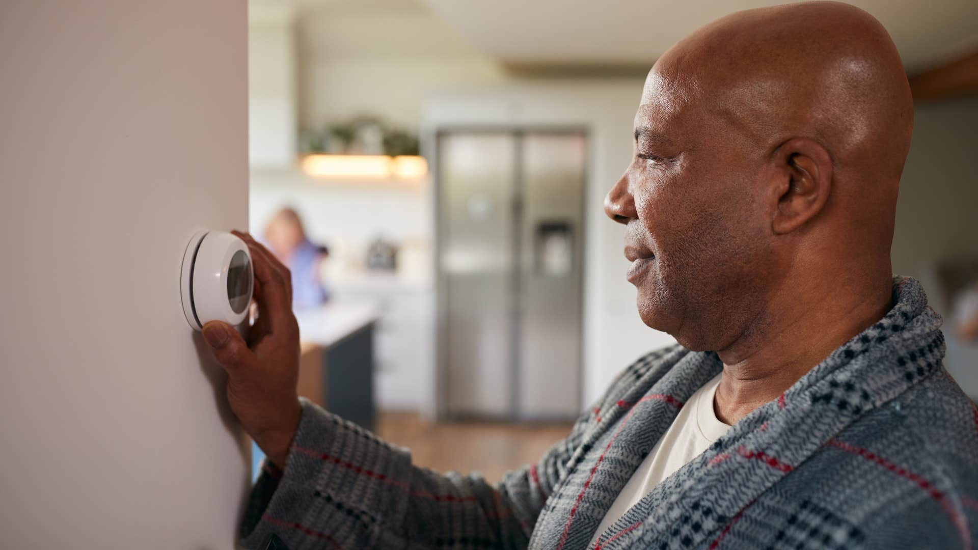 frugal man keeping thermostat usage strict
