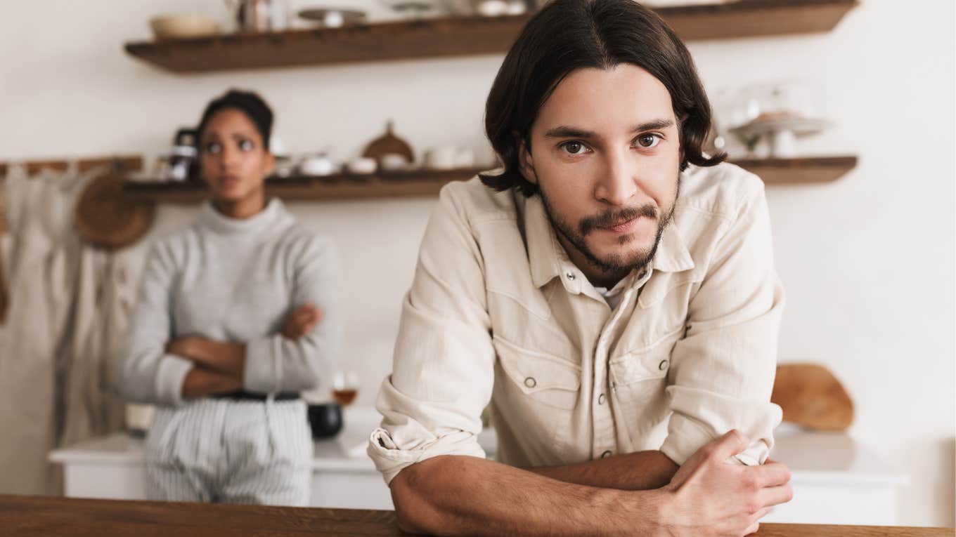 couple preparing dinner man looking uninterested in wife