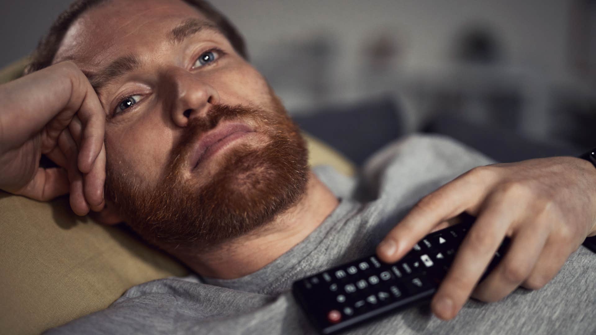 depressed man watching television 