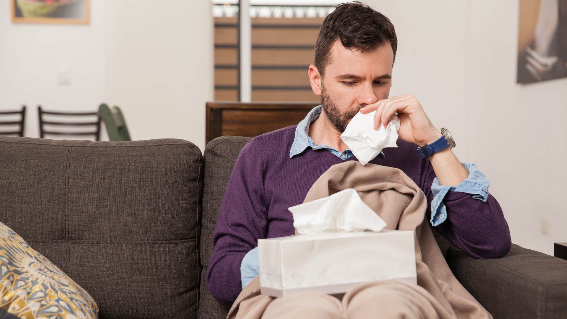 sad man overusing his tissue boxes