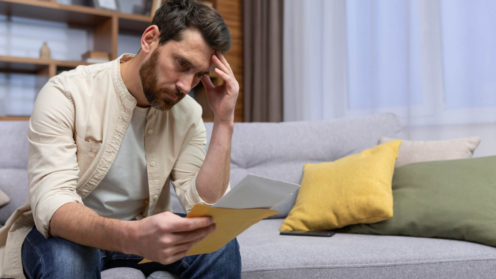 sad man opening his mail