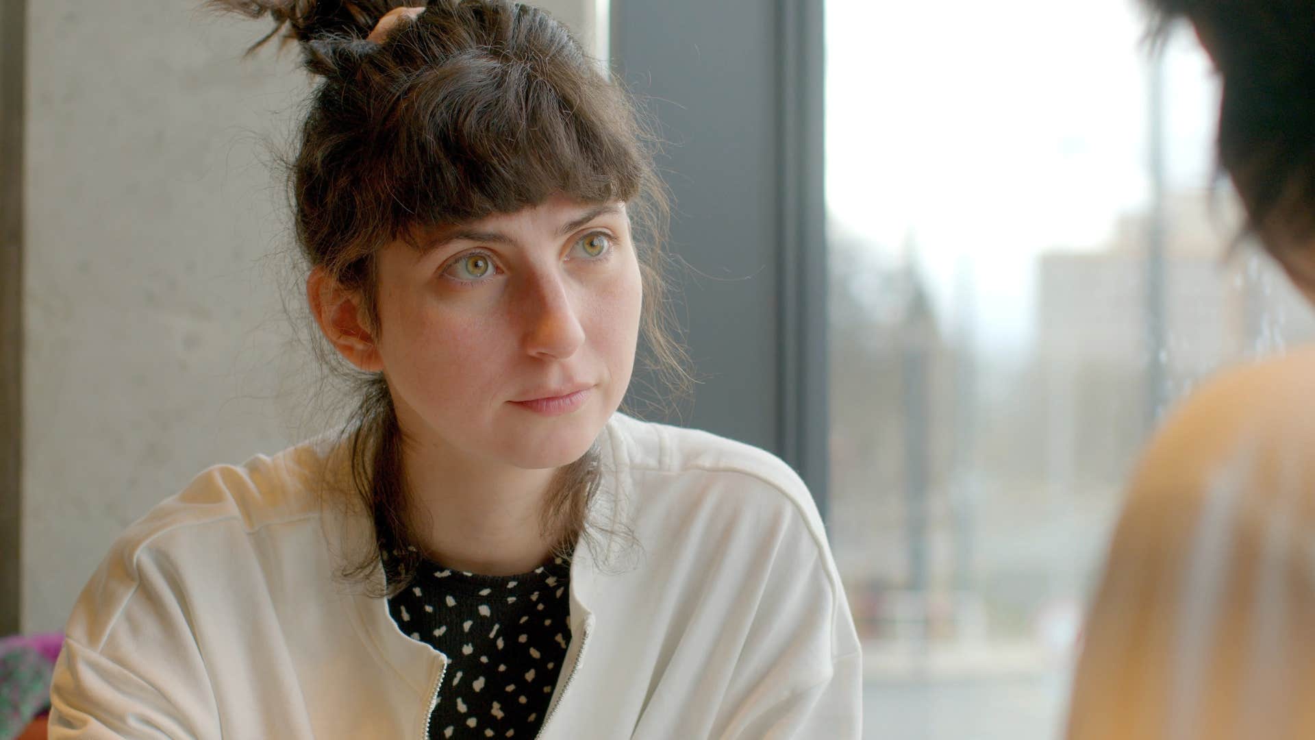 a woman listens to her friend say mean things that she claims is just honesty