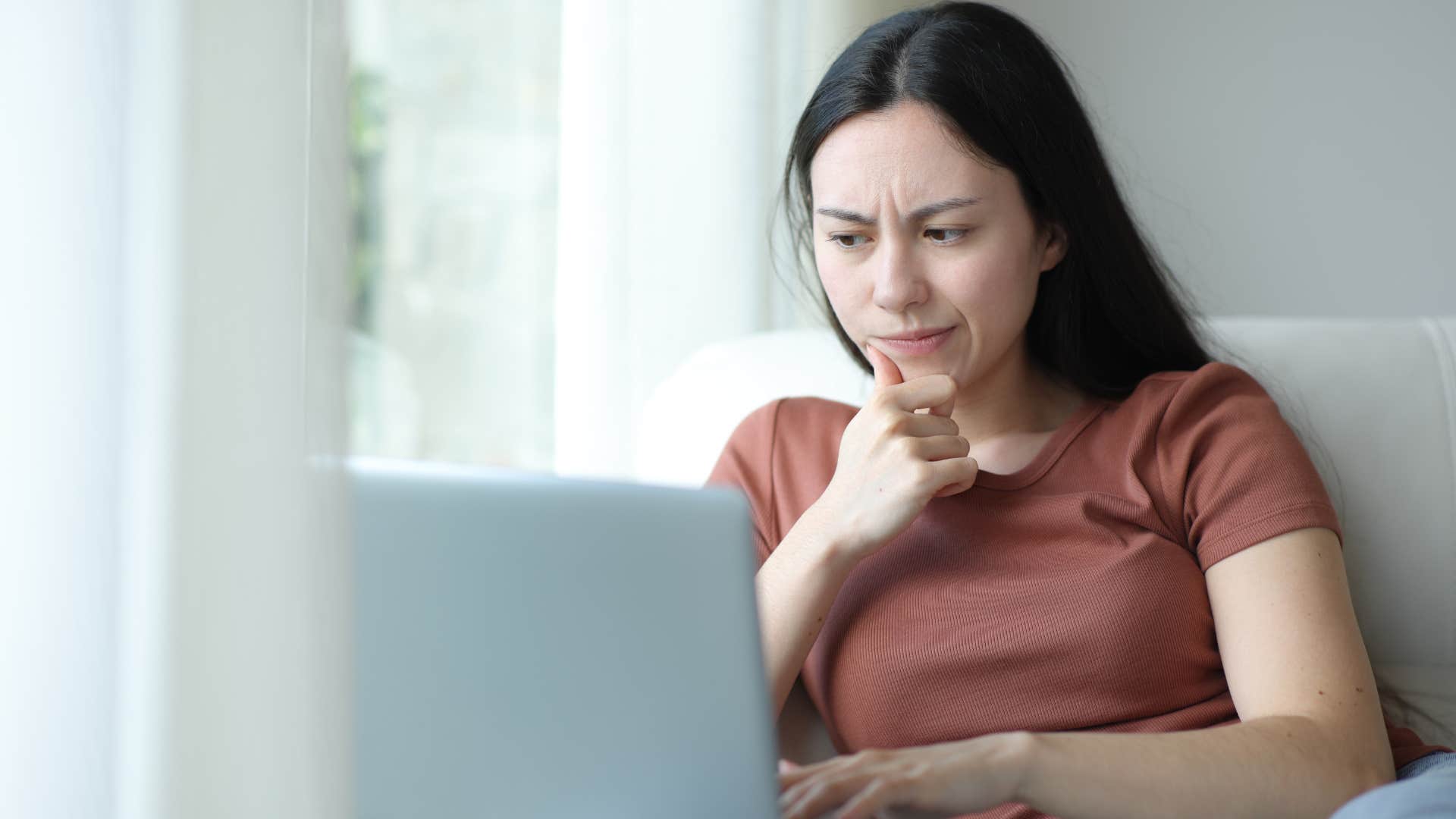 a woman looks over all of her unused subscriptions on her laptop
