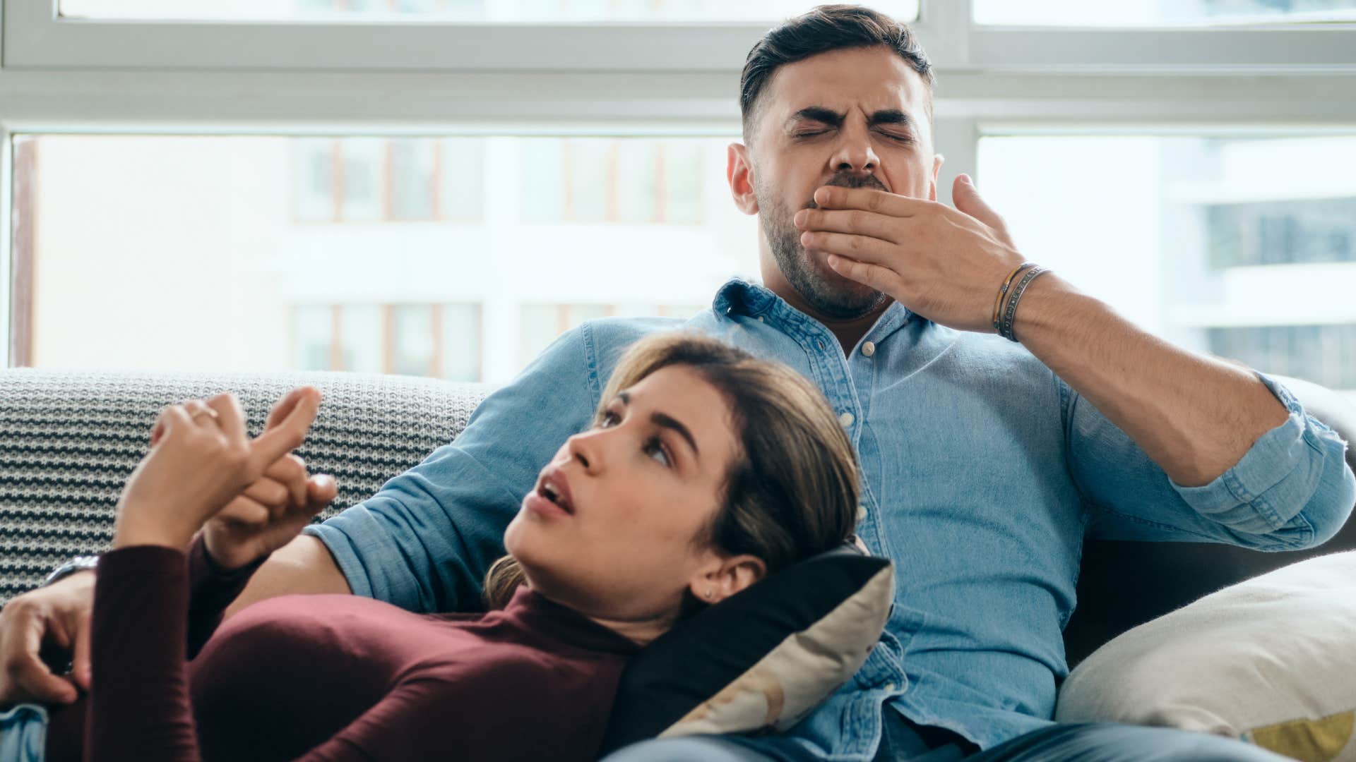 yawning man not paying attention to wife