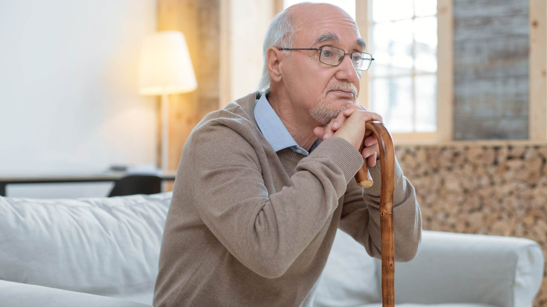 Man sitting on the couch in his home with safety issues.