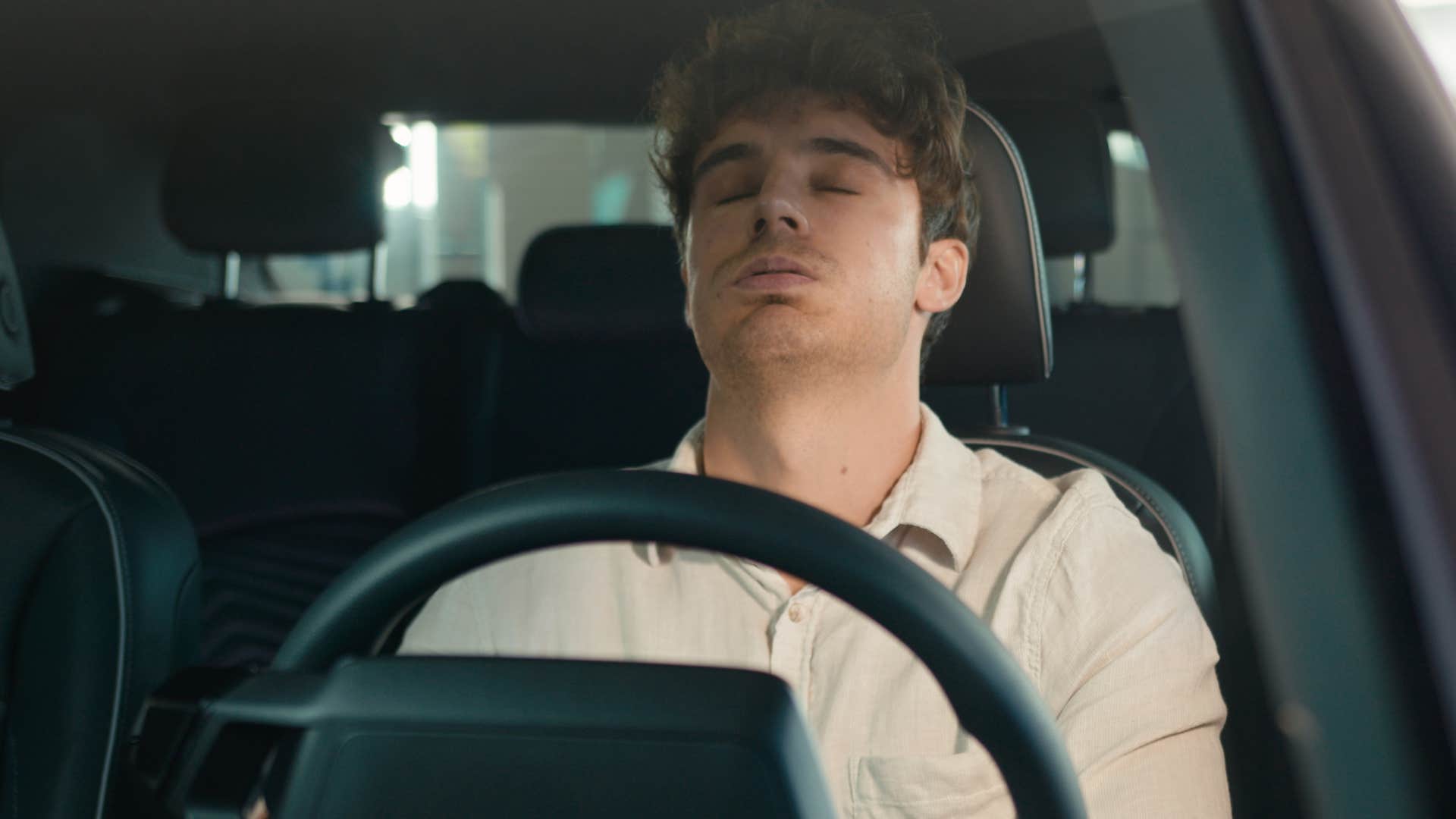 stressed man looking at an overdue oil change and engine lights in his wife's car
