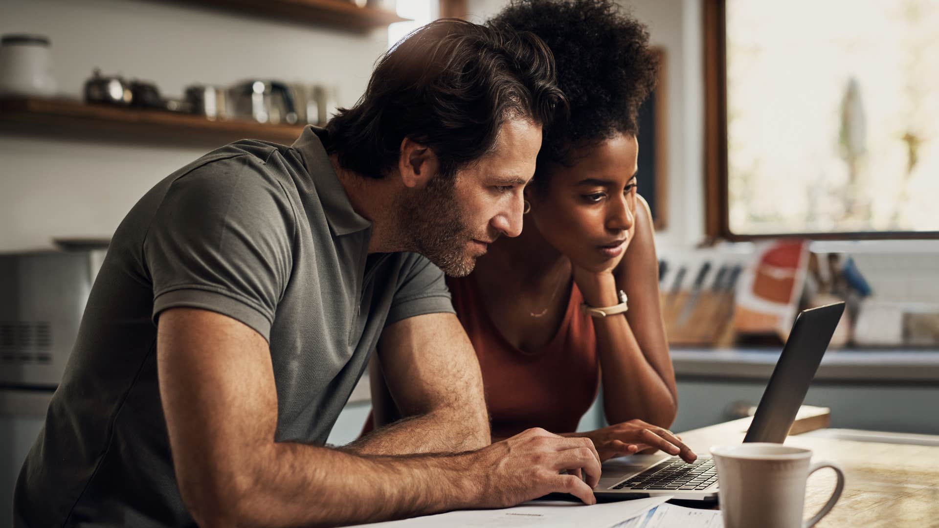 Couple who's intentional with money doing bills.