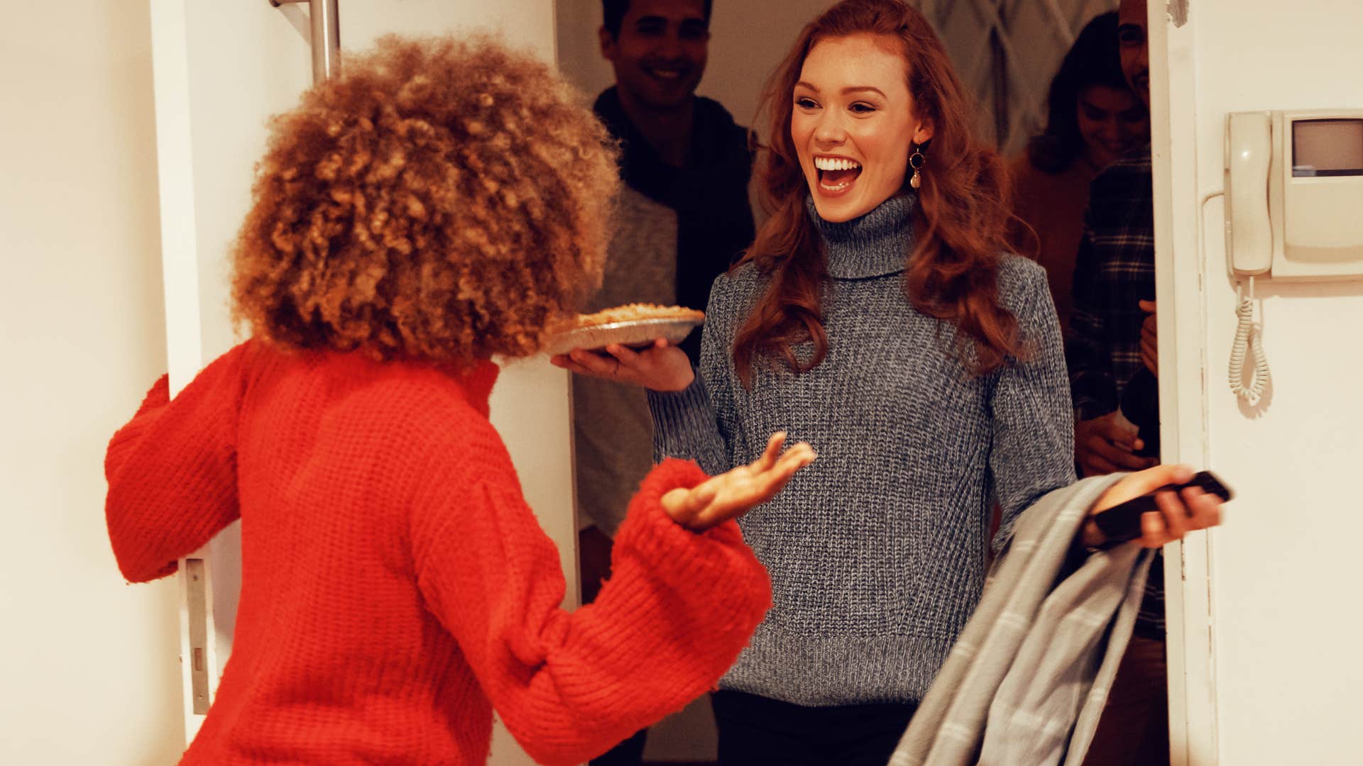 Woman who shows up on time smiling in the entryway.
