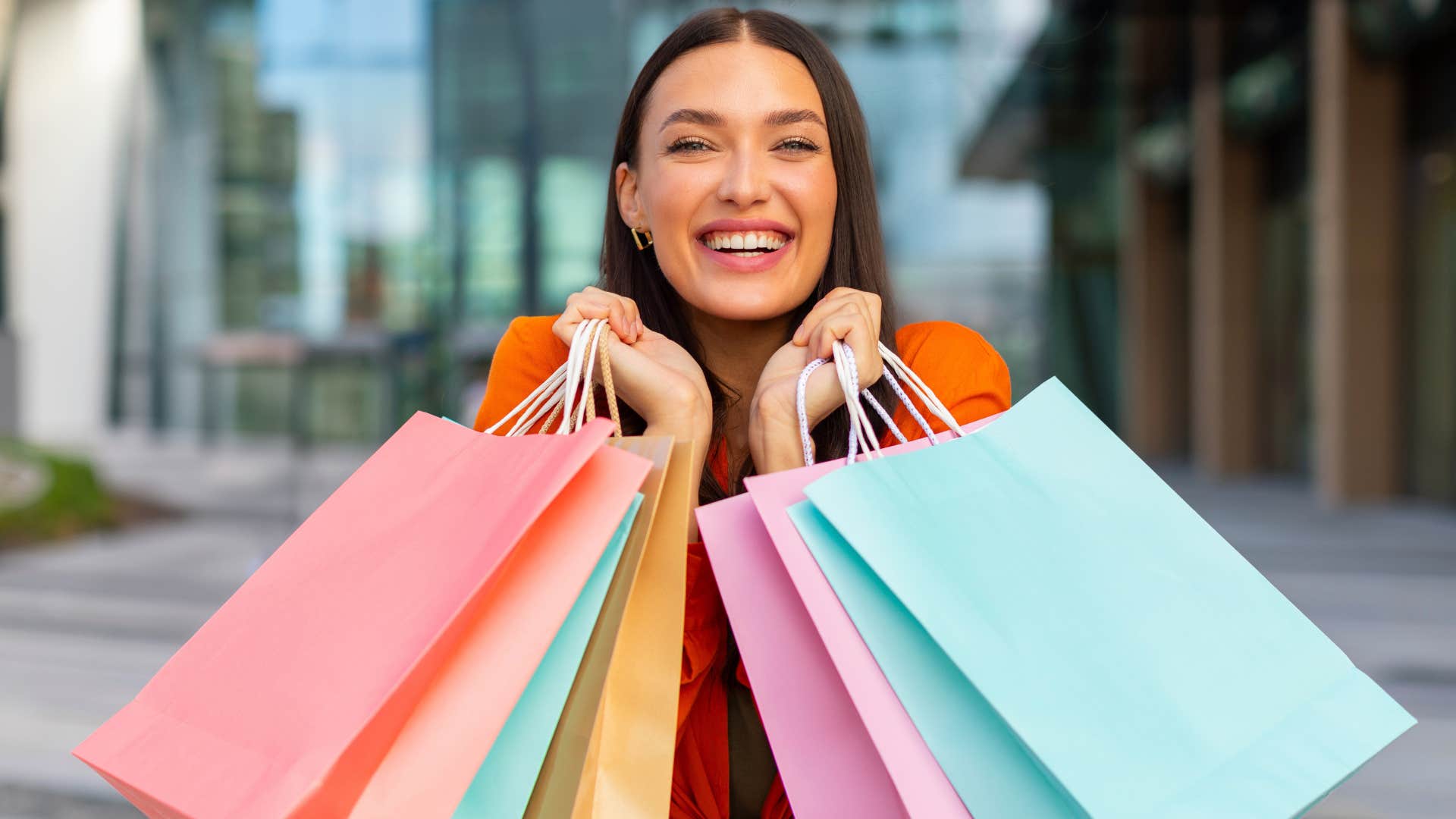 woman holding bags after going shopping at the mall