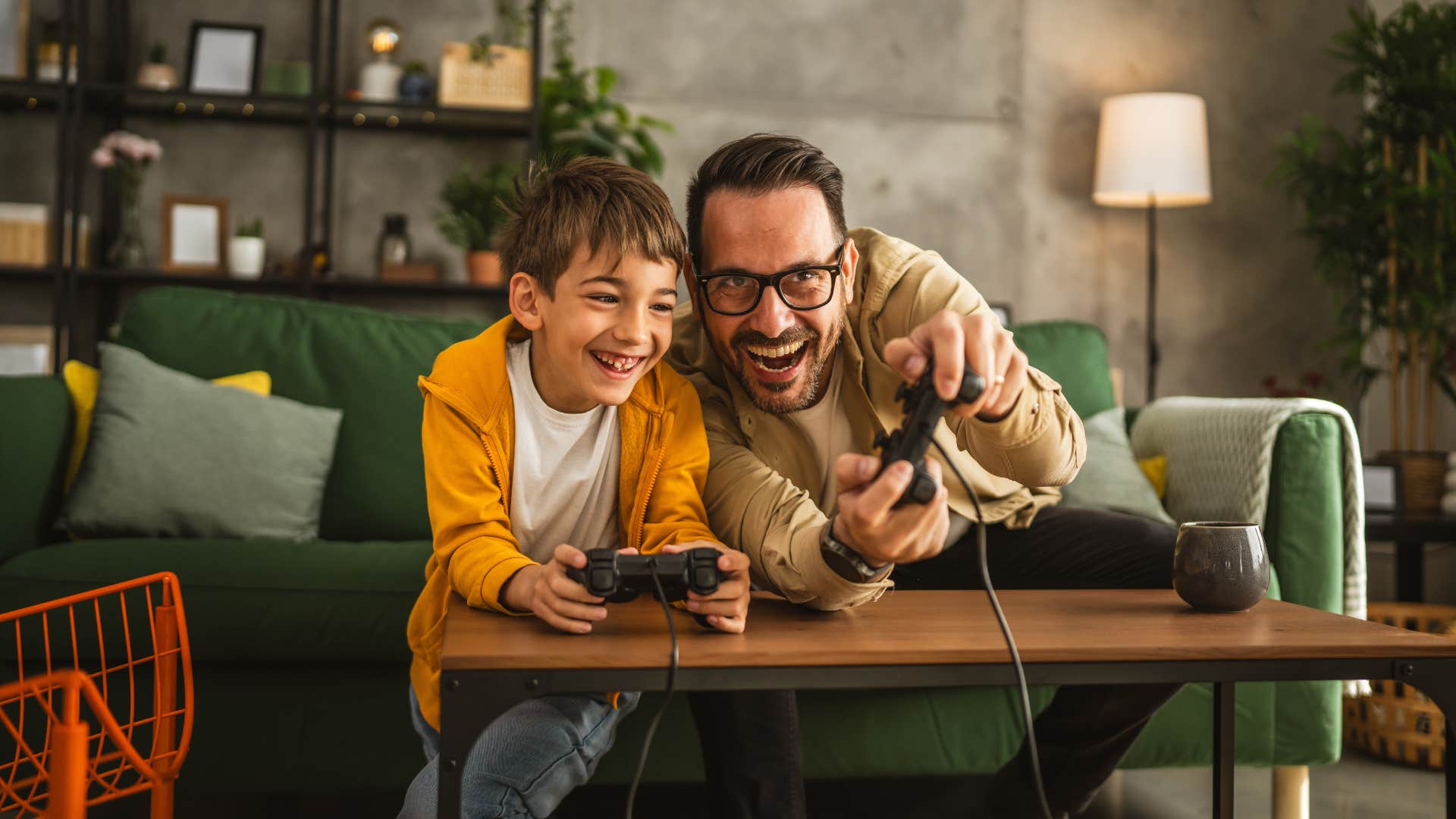 father and son playing video games together