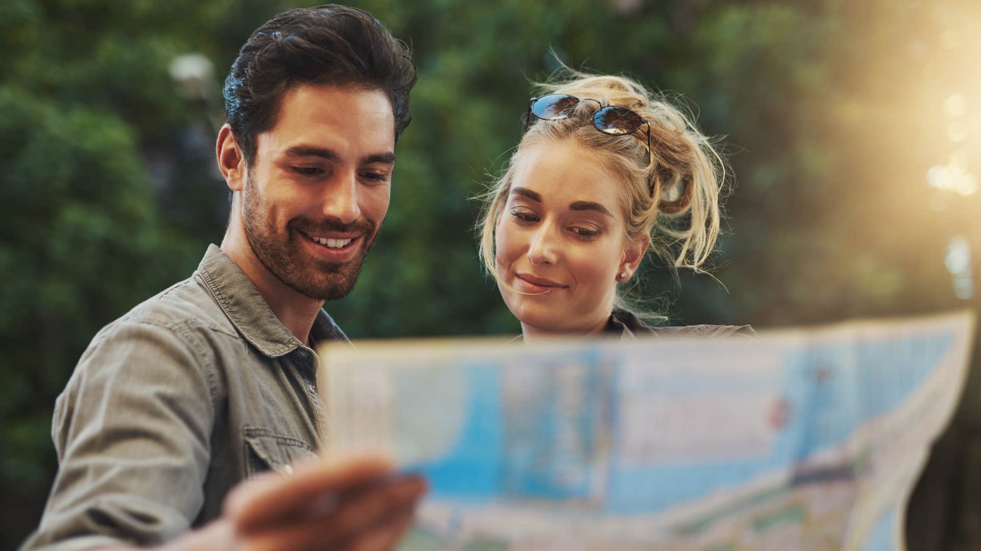 couple using a paper map to navigate