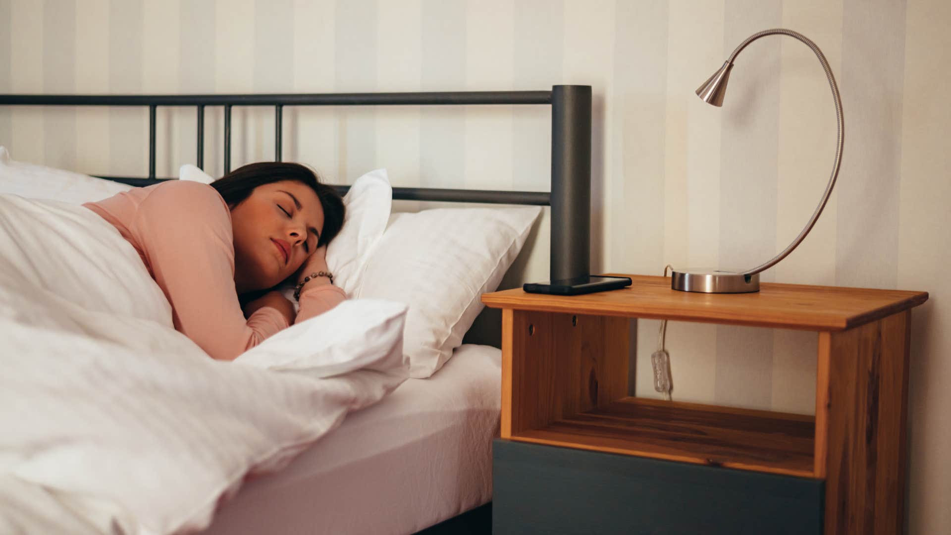 woman sleeping beside nightstand