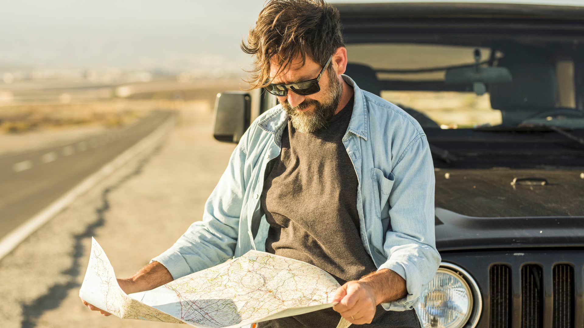 Man printing out directions and using them on the road.