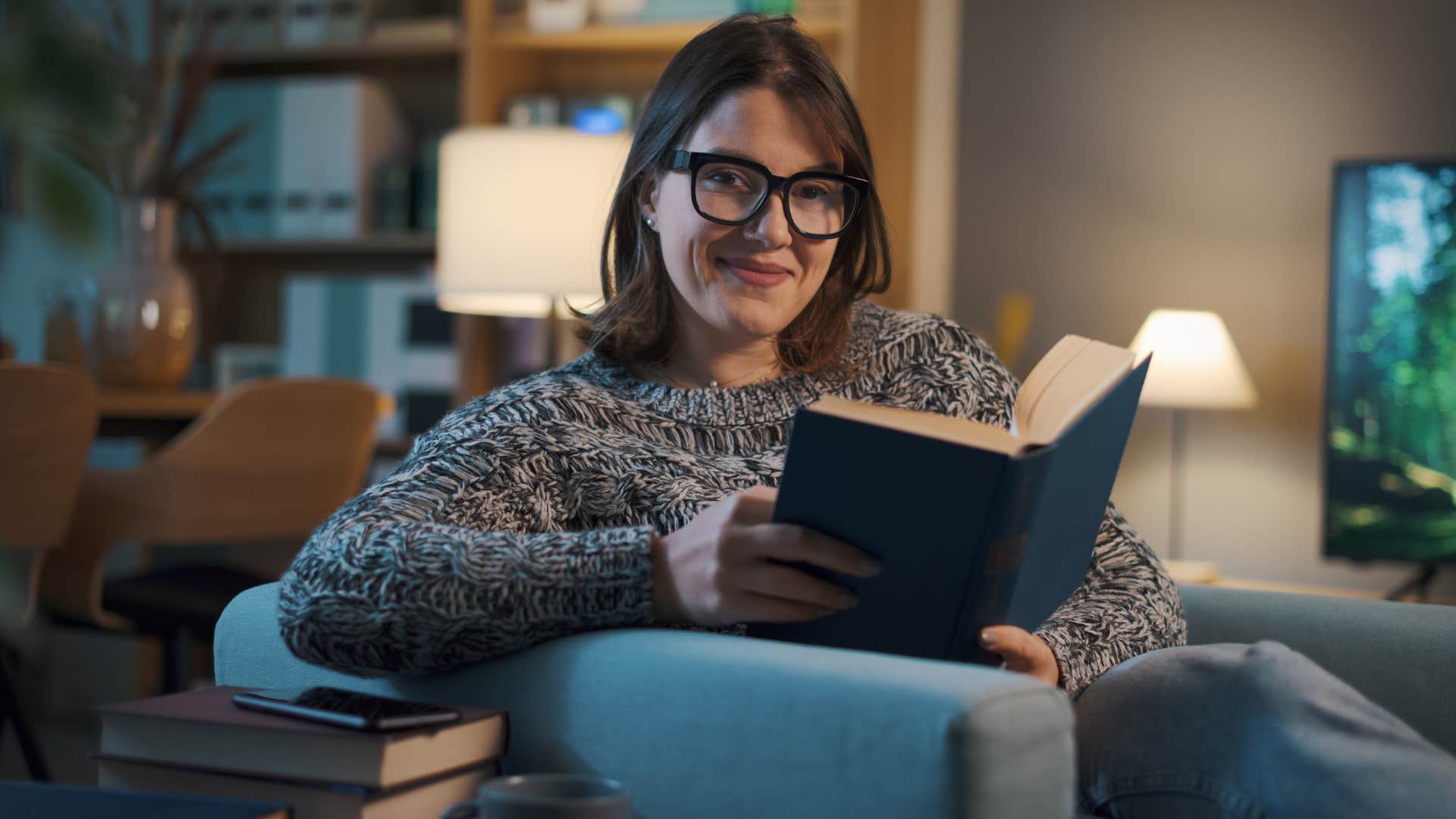 Woman with introvertedness traits reading at night.