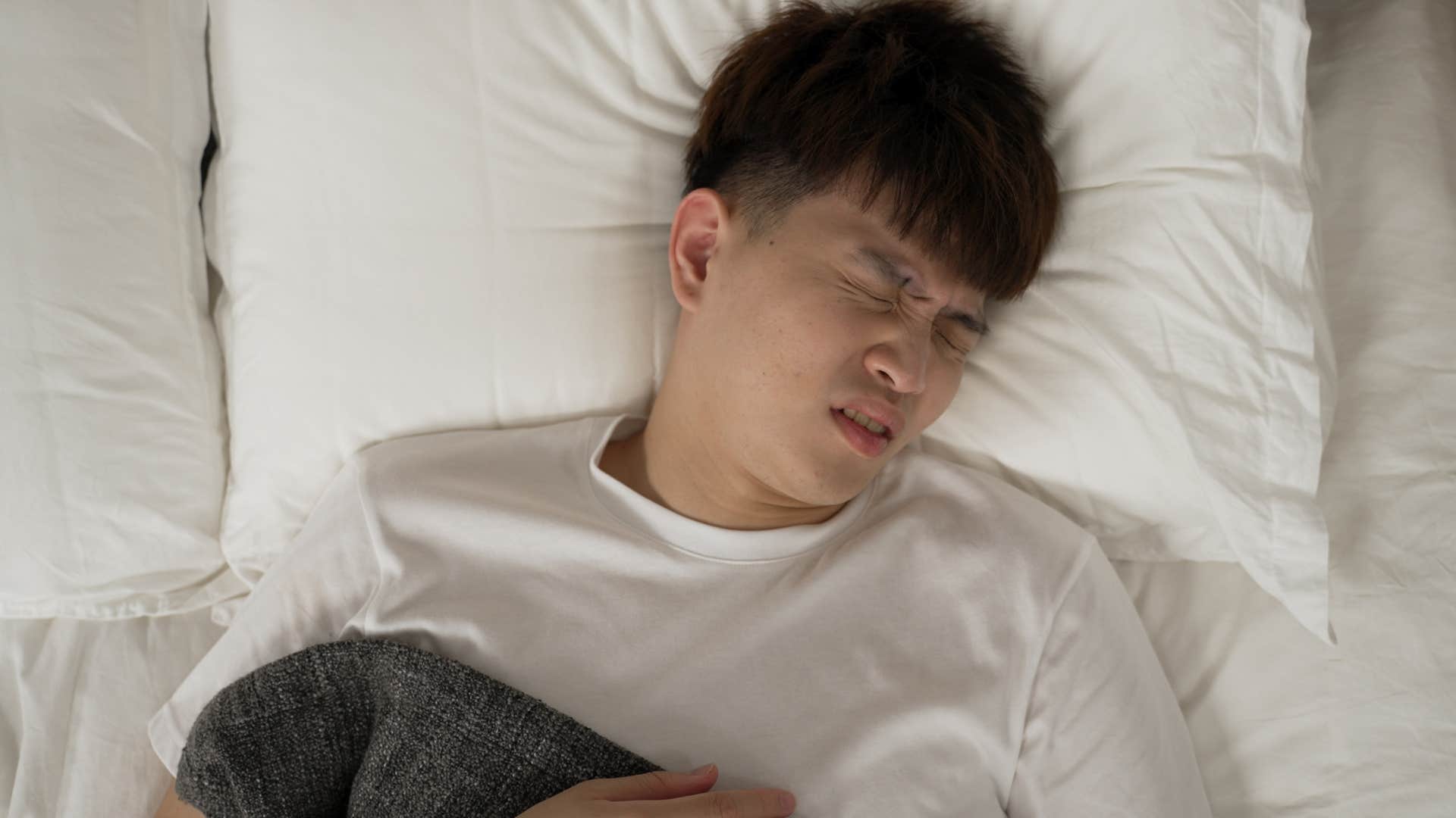 Man with a tendency toward vivid dreams laying in bed.