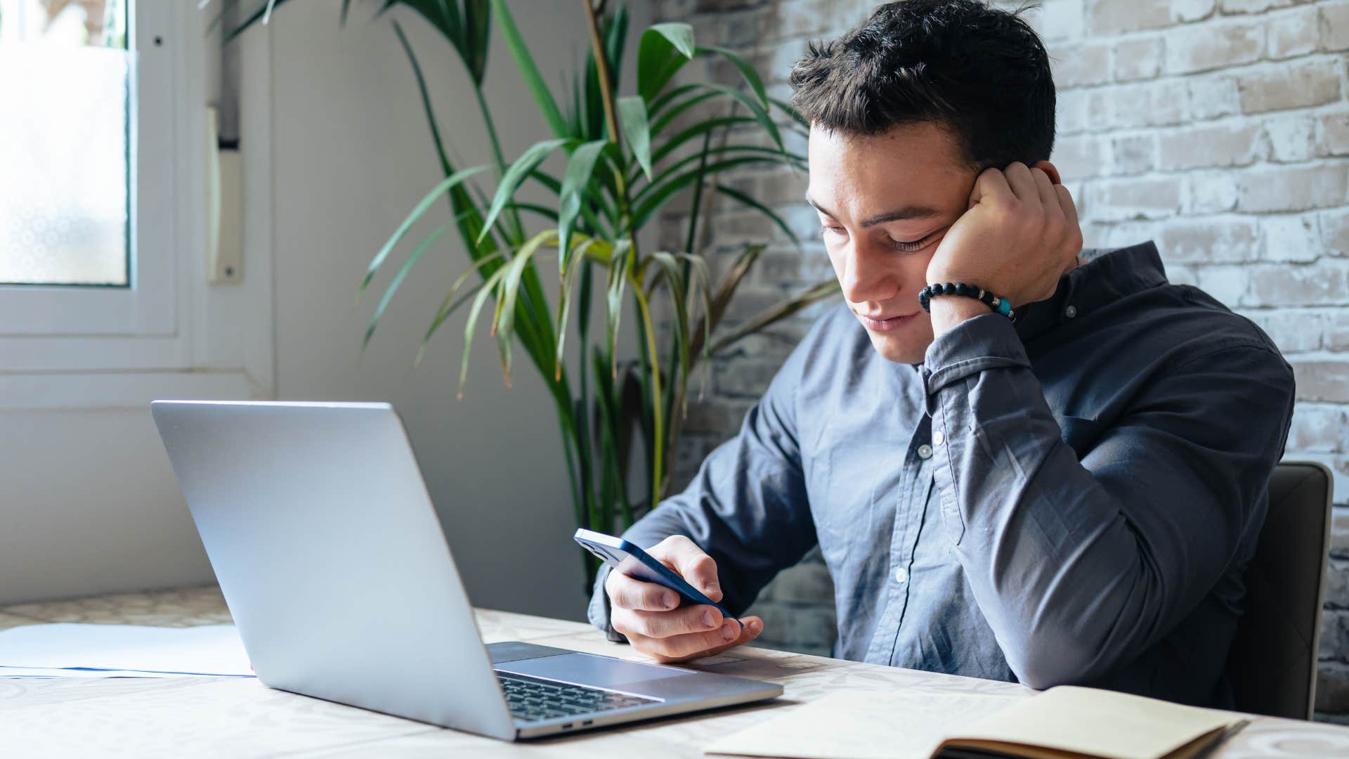 Man who's always on your phone sitting at work.