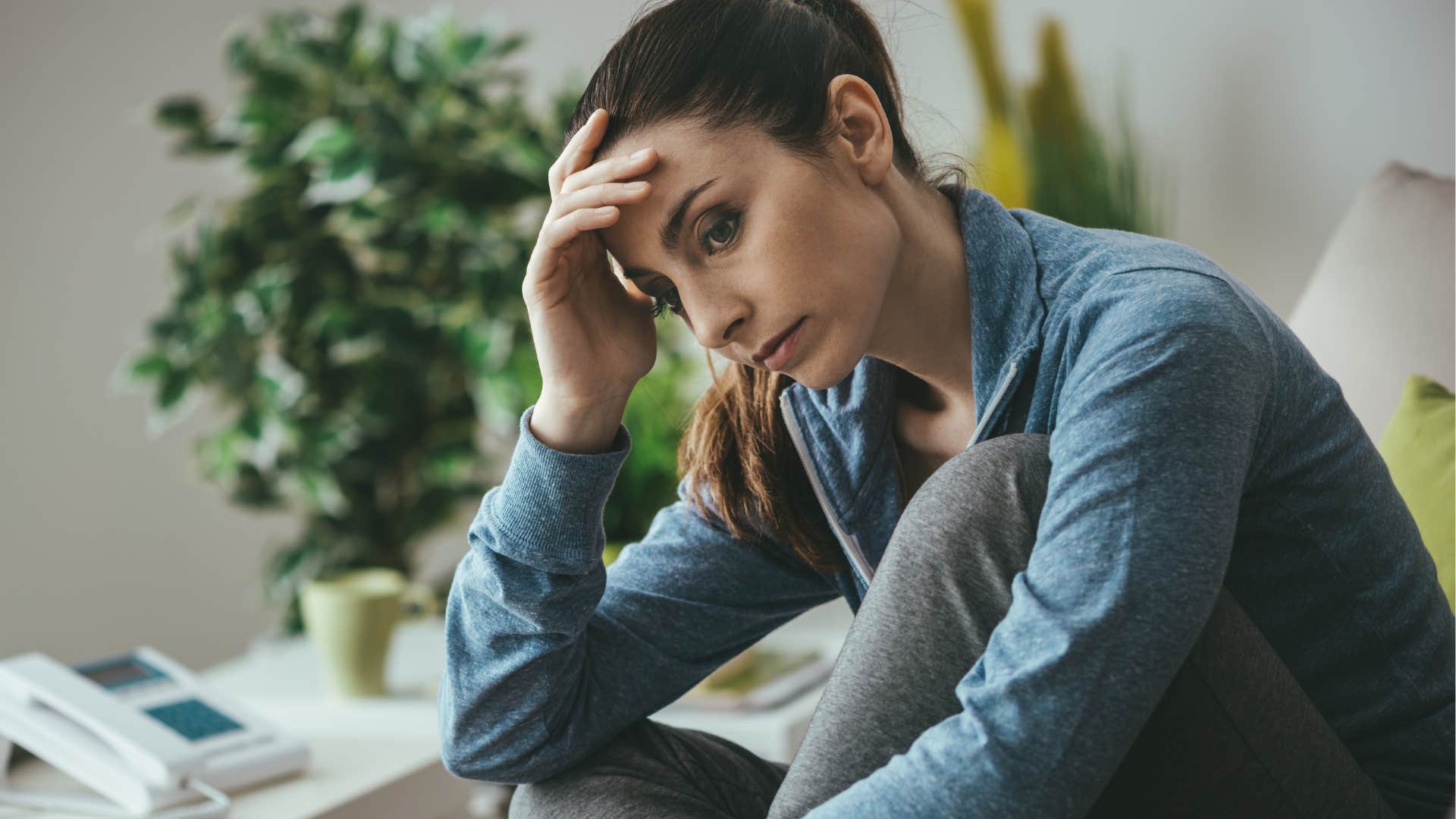Woman who gets anxiety on Sunday sitting in her bed.