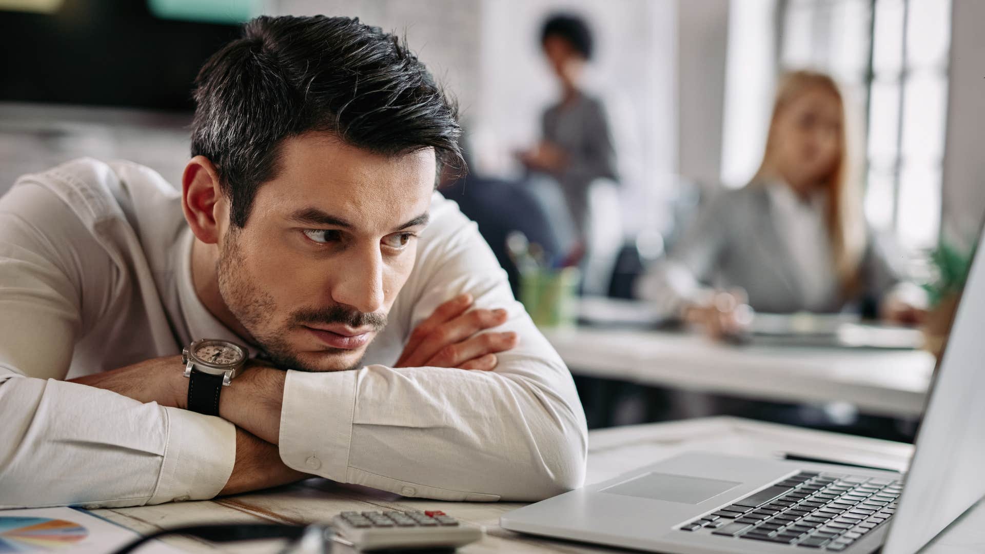 Man who avoids co-workers putting his head on his desk.