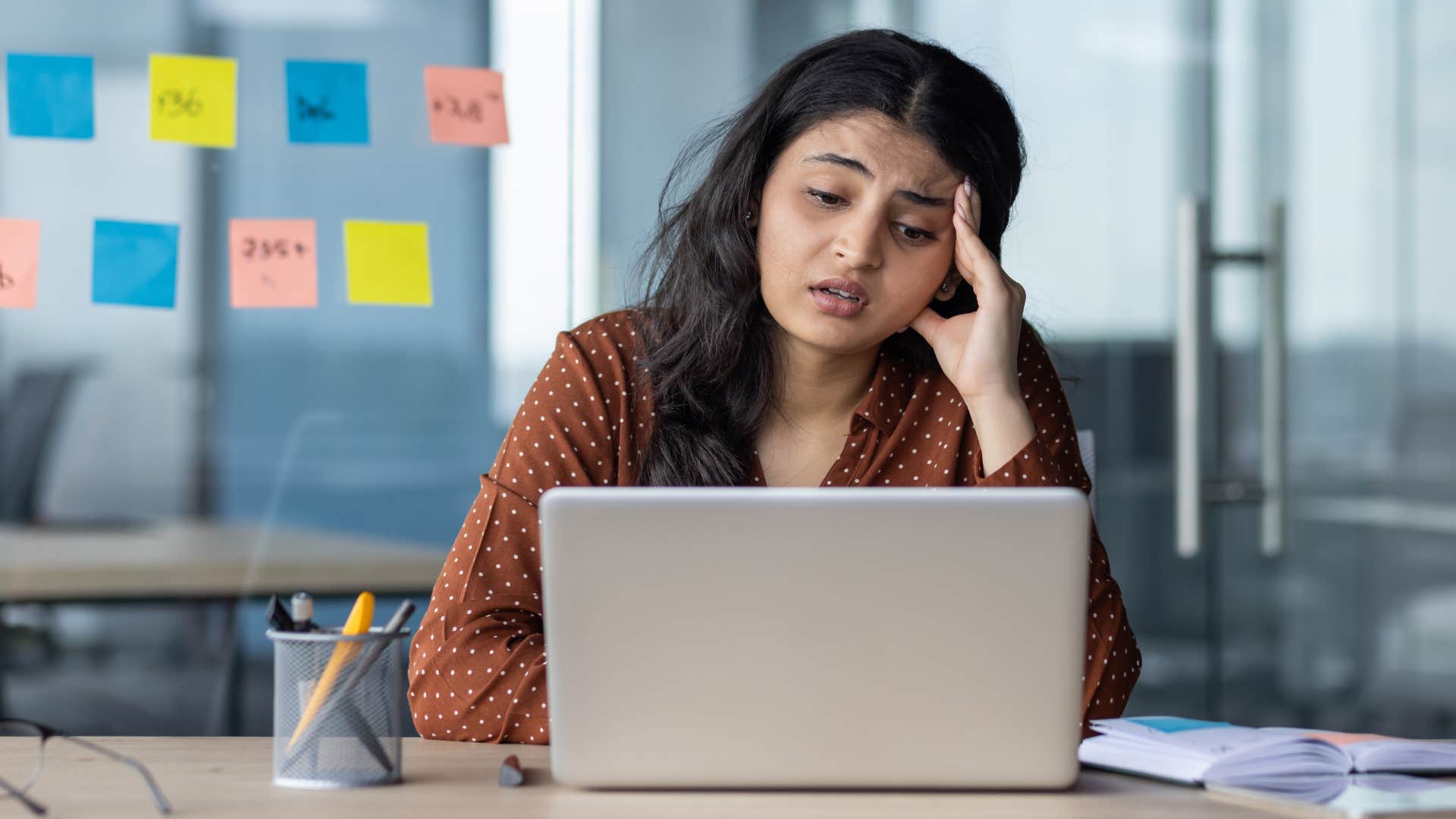 Woman daydreaming about quitting at work.