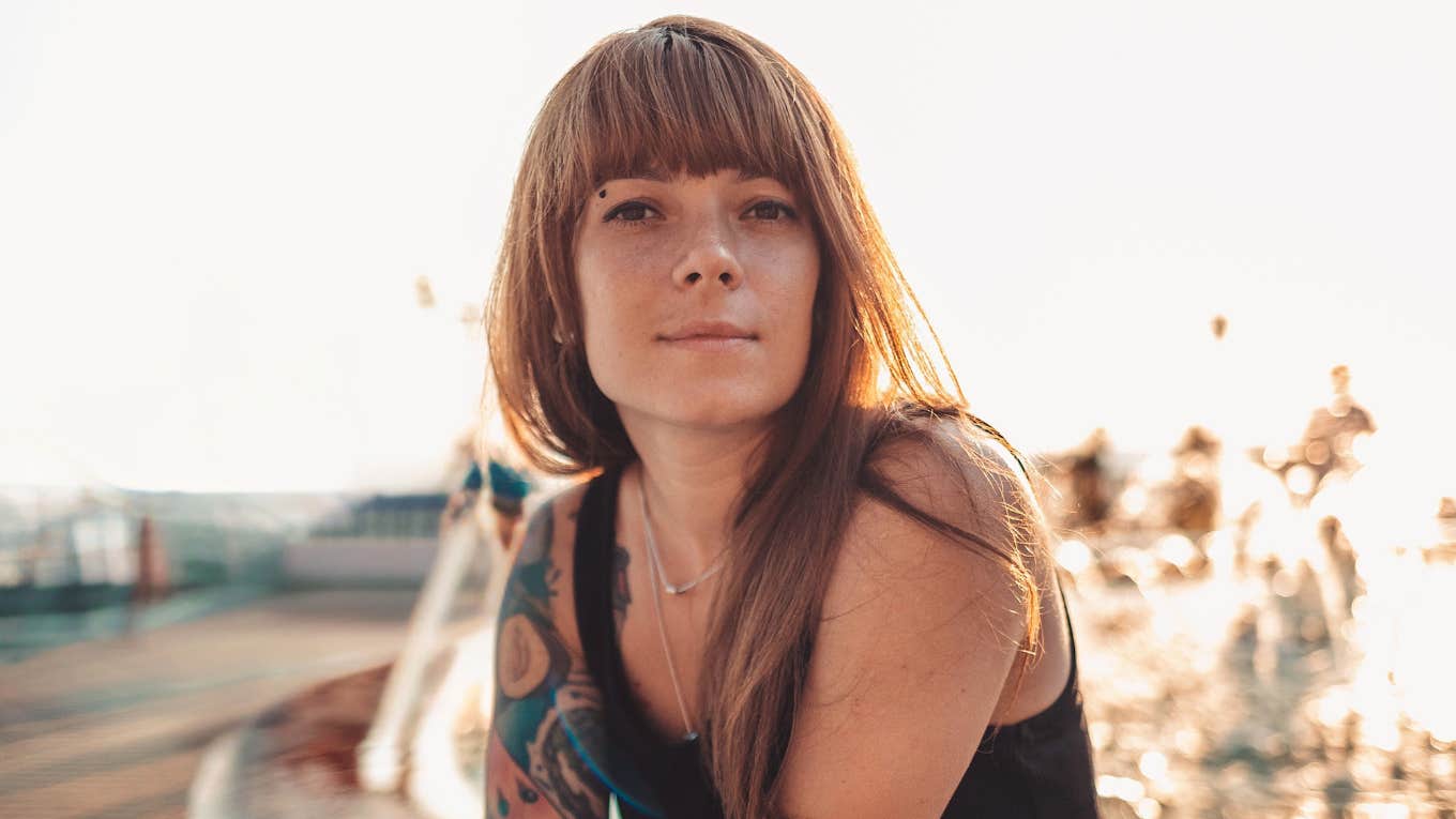 happy woman sitting outside after a spiritual awakening