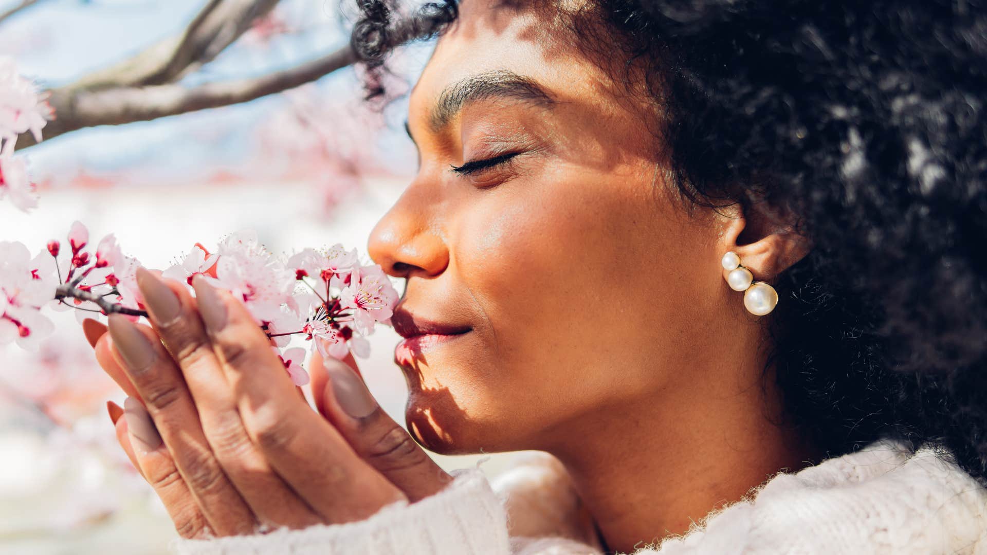 woman smelling flowers with heightened senses