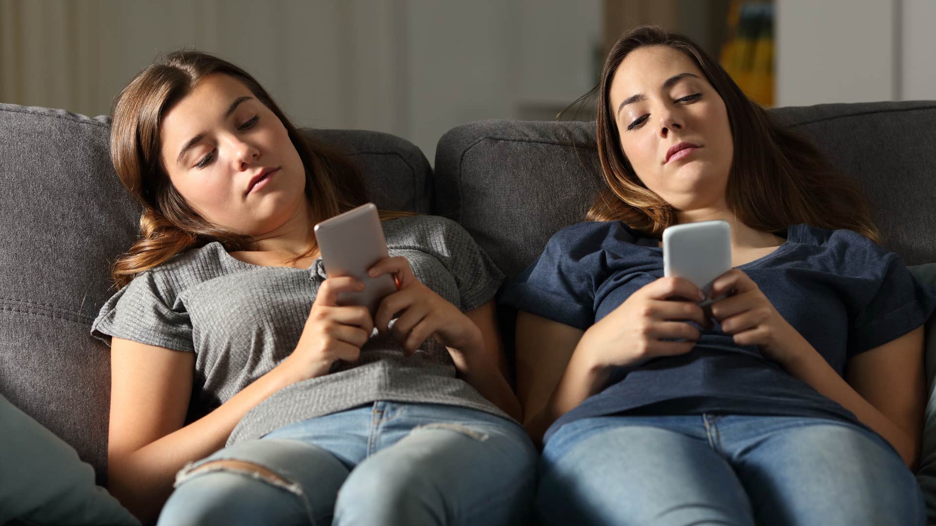 teenagers on the couch on their phone skipping their homework assignment