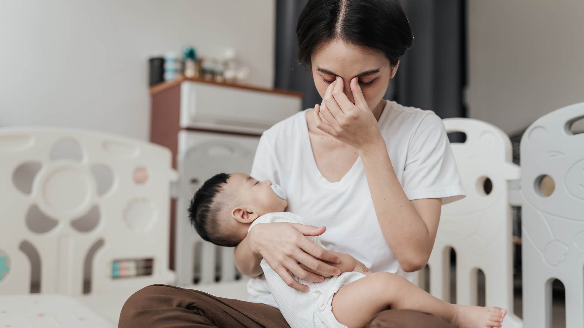 exhausted single mom holding baby