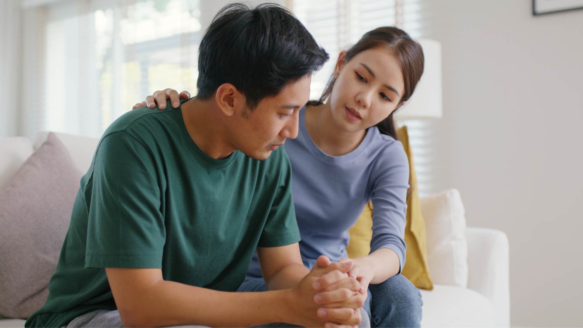 man in green shirt upset as he downplays his role in the family and woman tries to comfort him