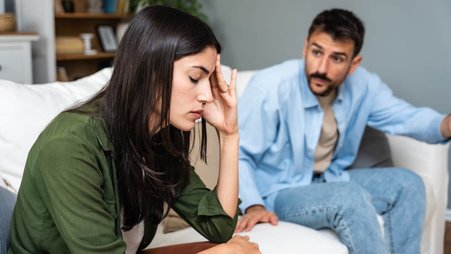 man in blue telling woman in green no one else would love you like i do as they argue on couch