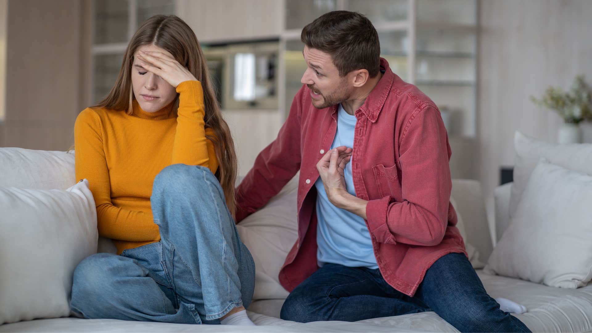 man in red jacket telling woman you made me do it while woman looks away