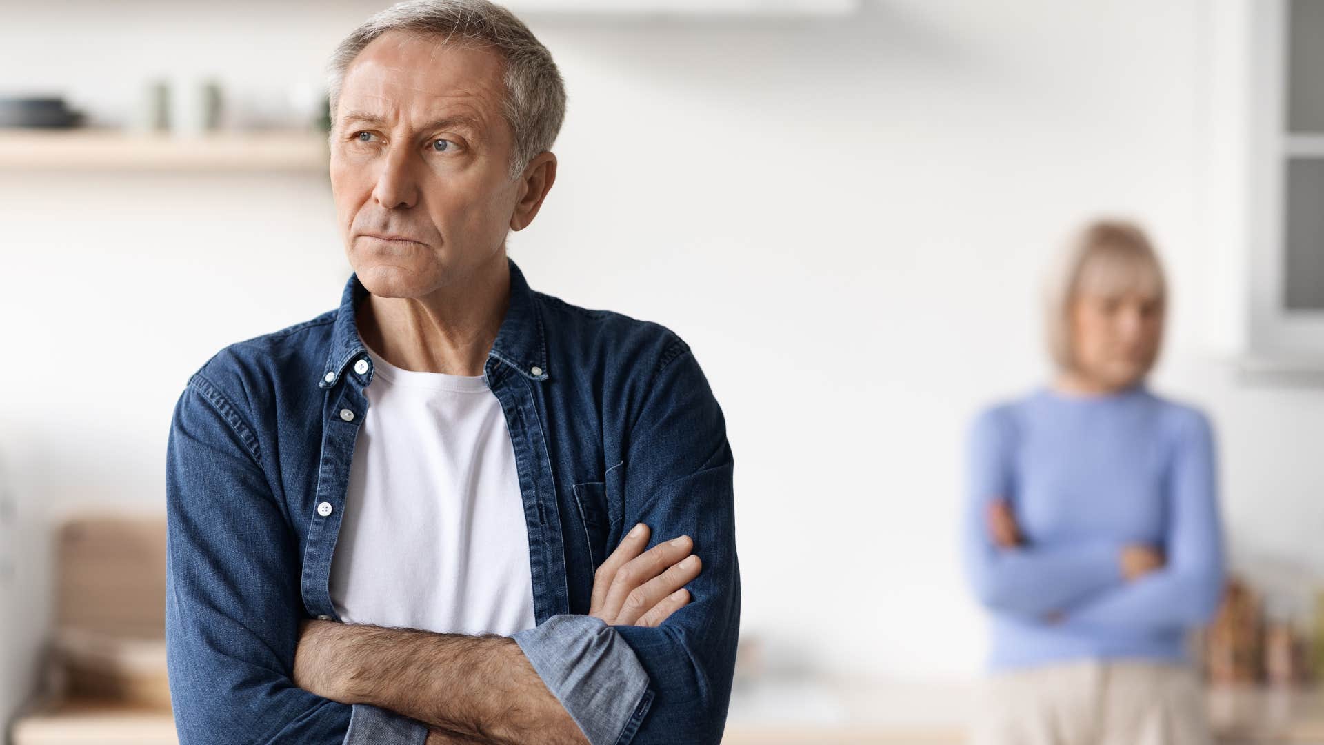 Man who avoids quality time together turned away from his partner.