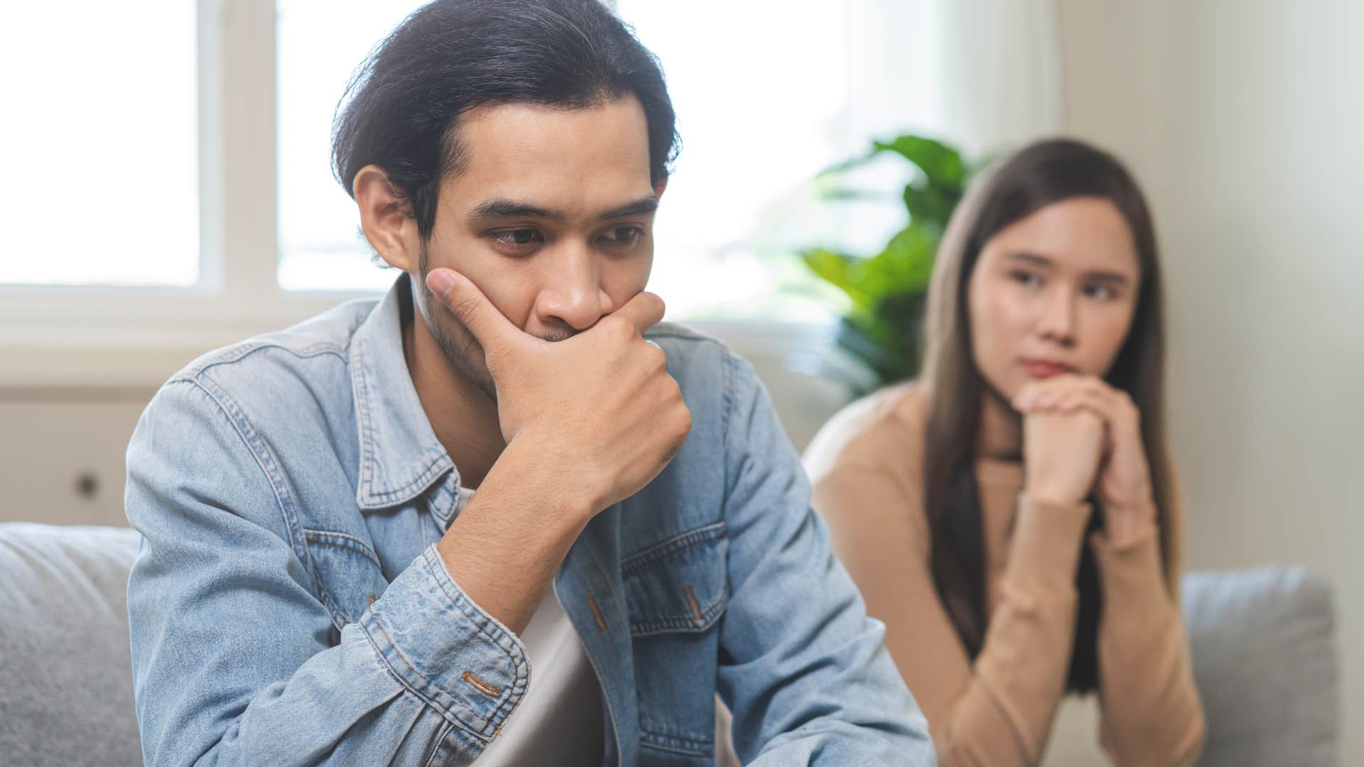 Man who's not physically intimate with his partner holding his face in his hands.