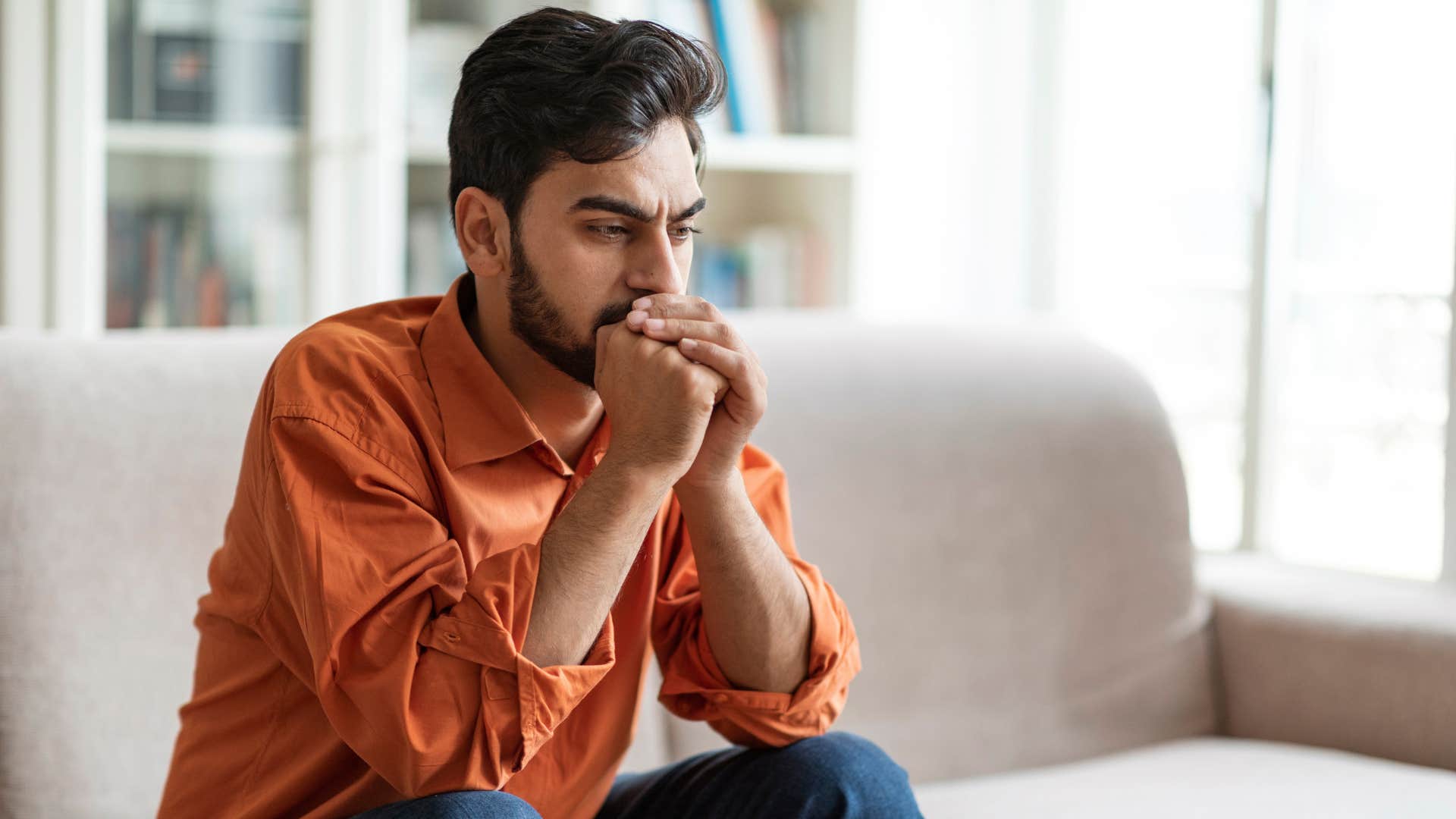 Man who spends more time alone sitting on his couch.