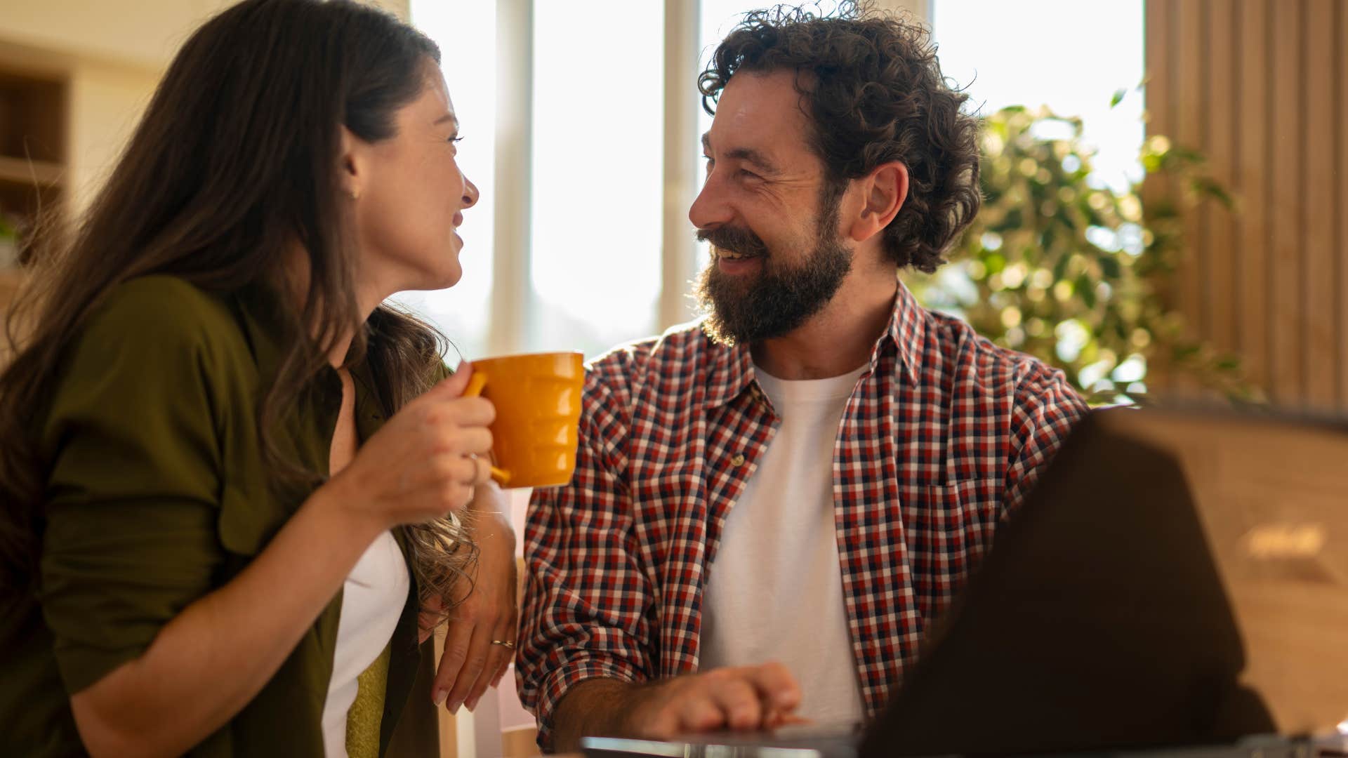 couple who communicates better sleeping alone smiling at each other