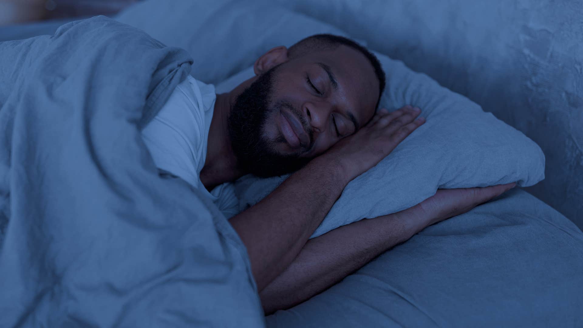 man with different bedtimes than his wife sleeping at night