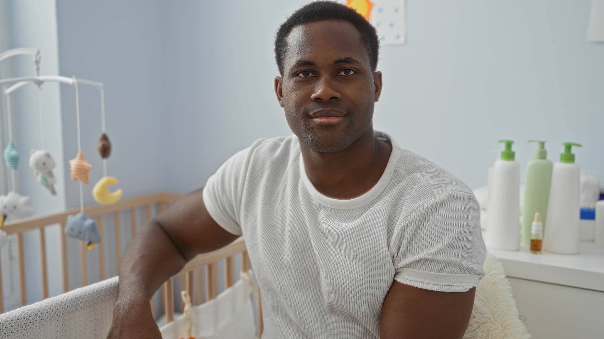 man sitting in a nursery dividing up parenting responsibilities
