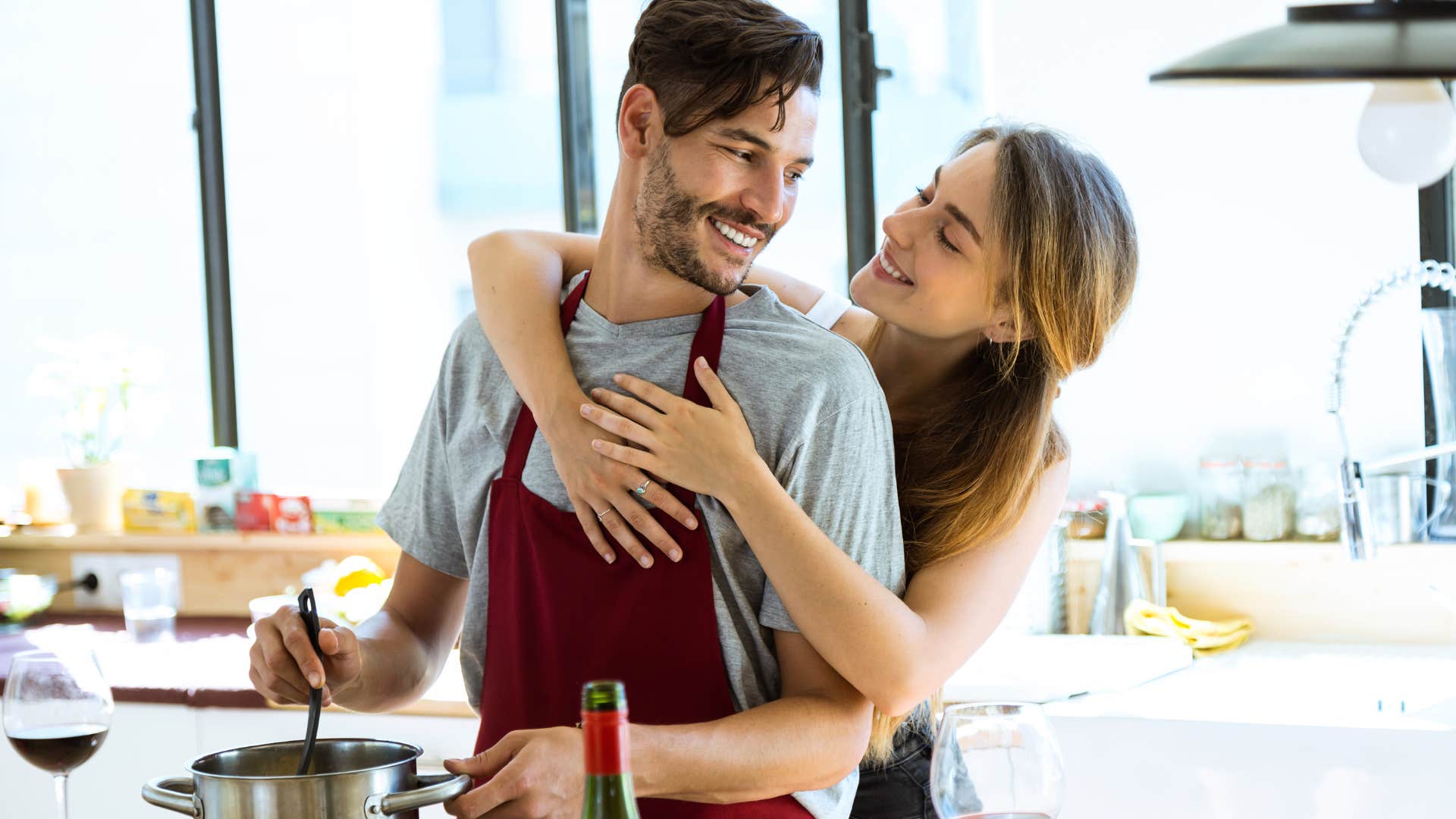 husband cooking meal for wife