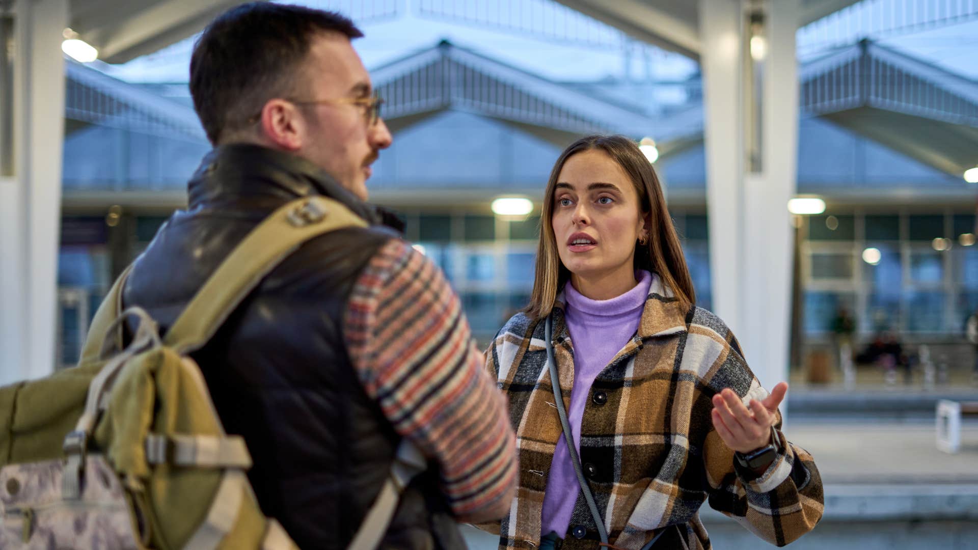 man saying can you not do that here to his upset wife in public