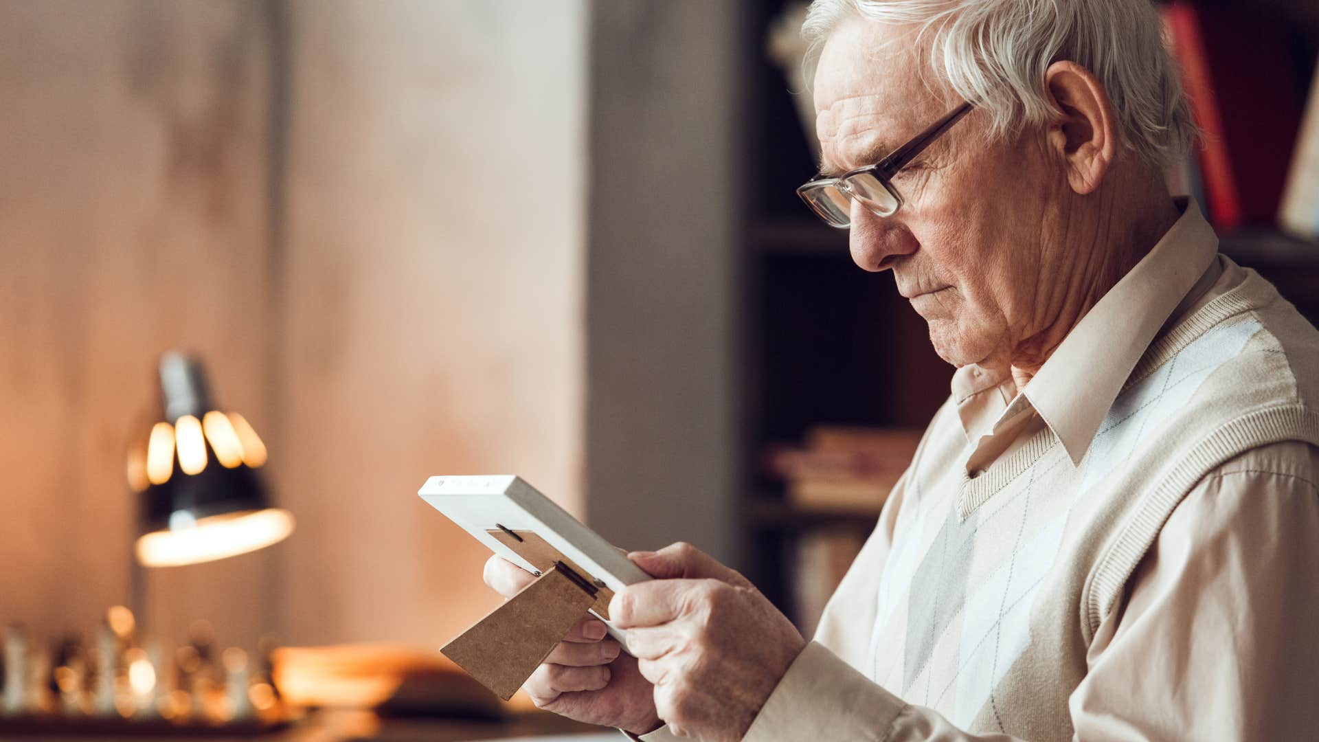 older man looking at photo