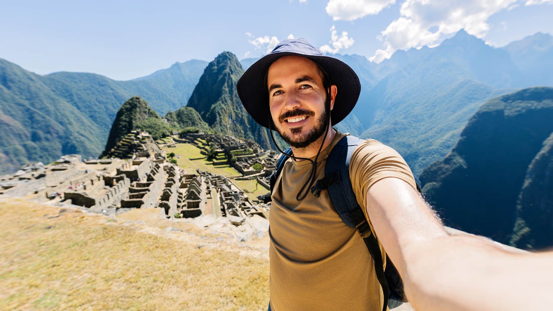 man taking picture while on trip to mountains
