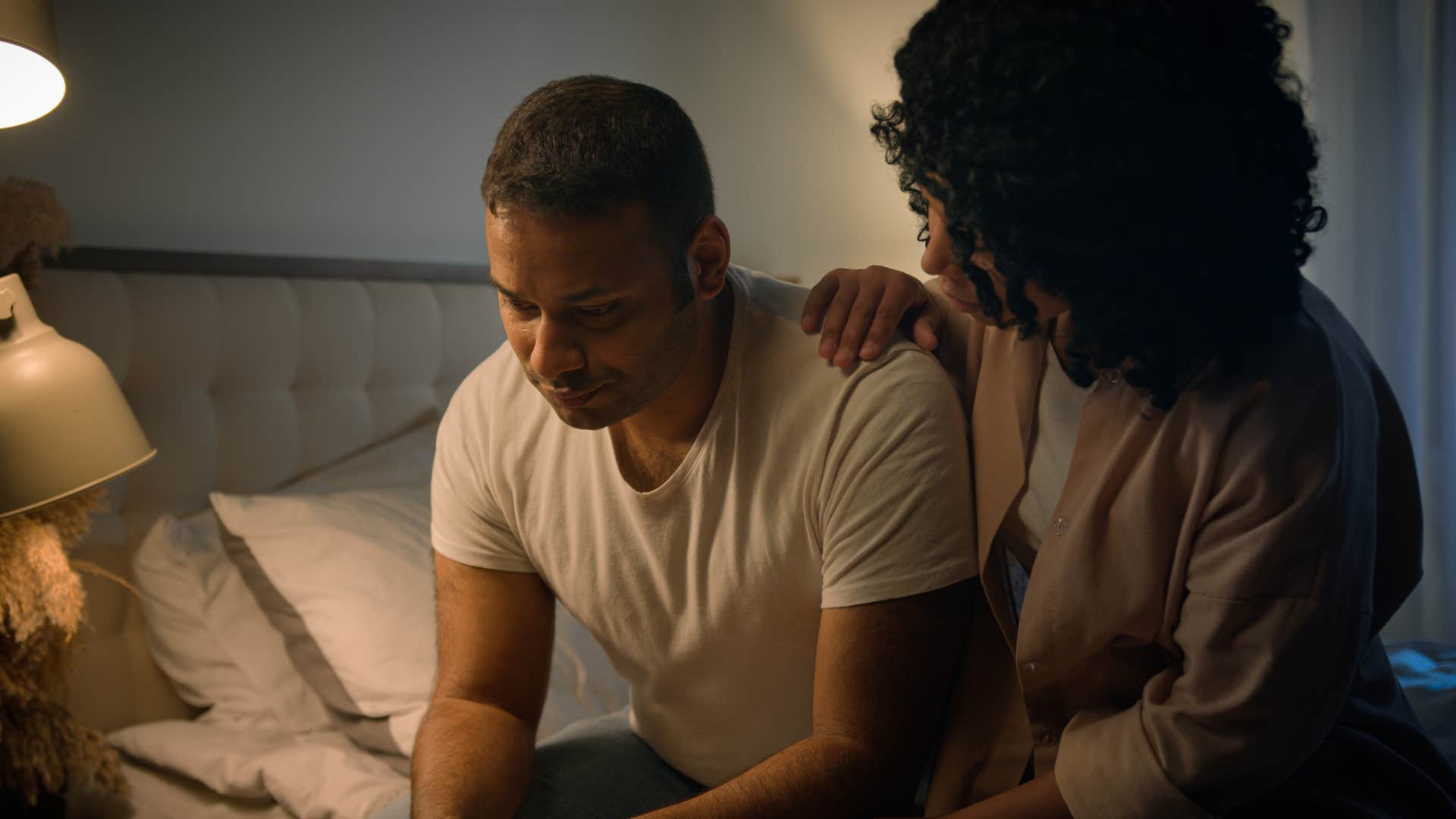 Woman comforting her husband who doesn't say "I love you."