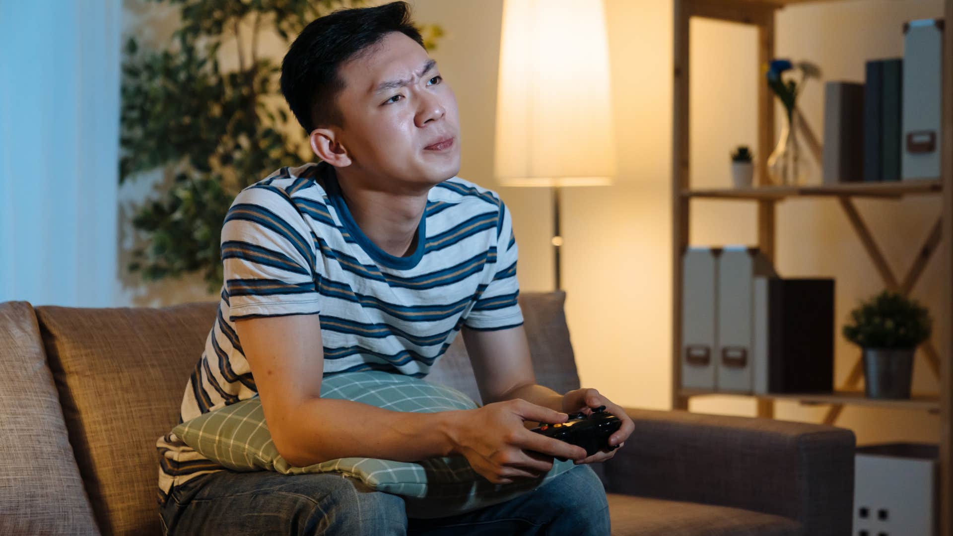 Man who stays up later than his wife playing video games.