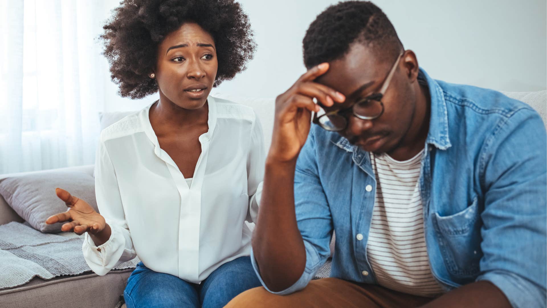 Man who avoids deep conversations turned away from his wife.