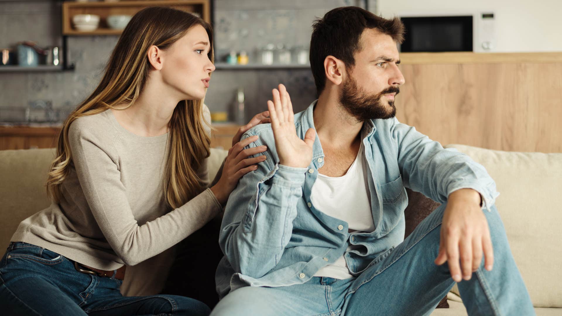 Man turned away from his wife who avoids spending time together.