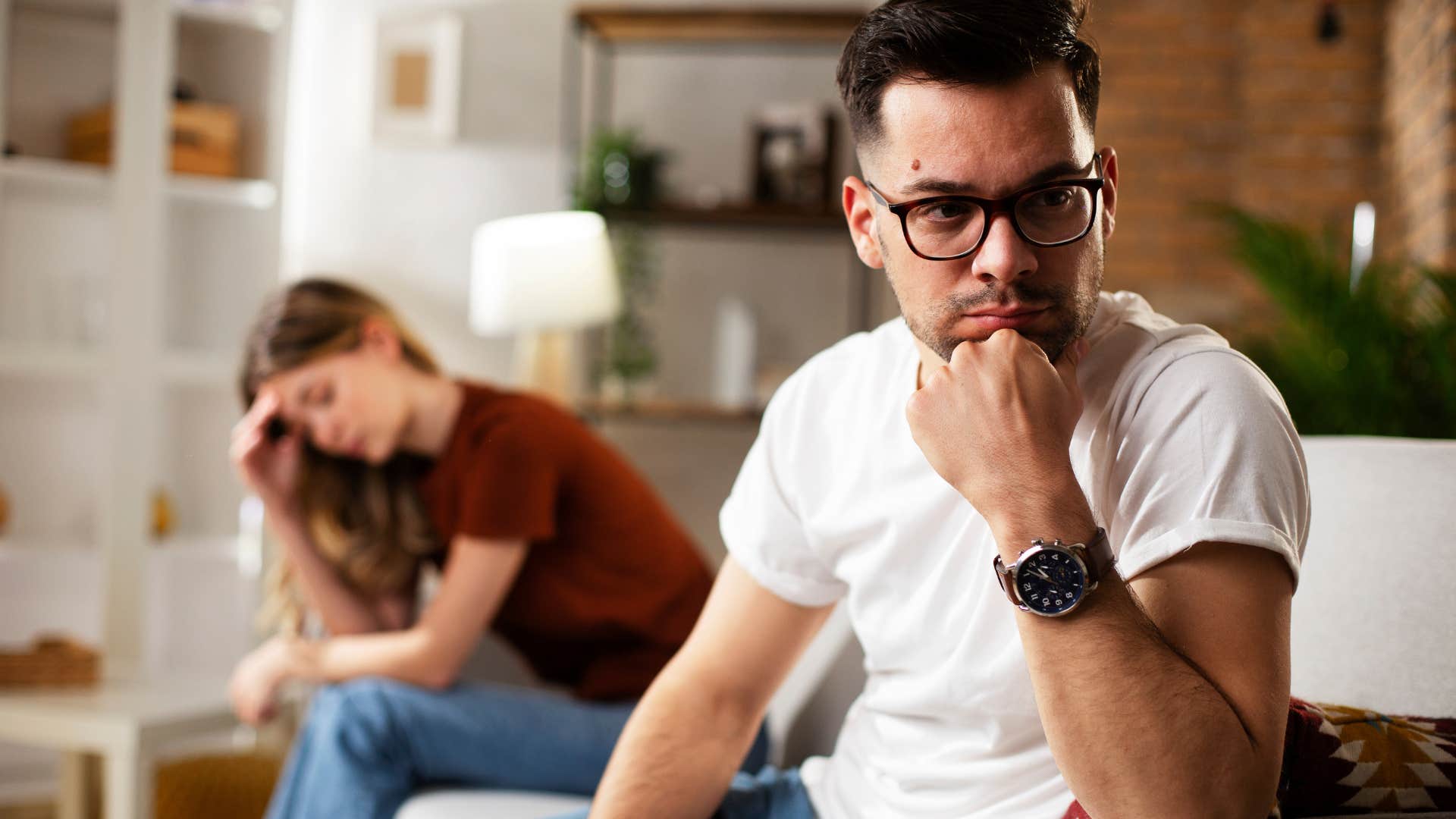 Man who keeps secrets turned away from his wife.