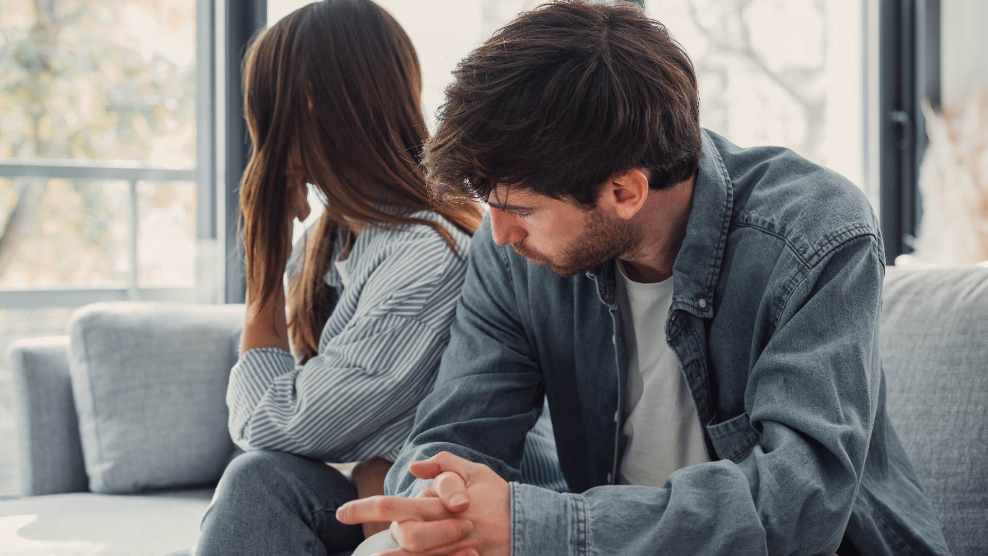 Man who's stopped complimenting their partner sitting at home.