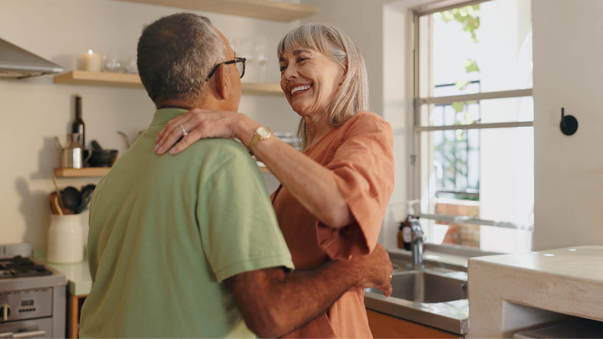couple with a strong sense of intimacy dancing in the kitchen