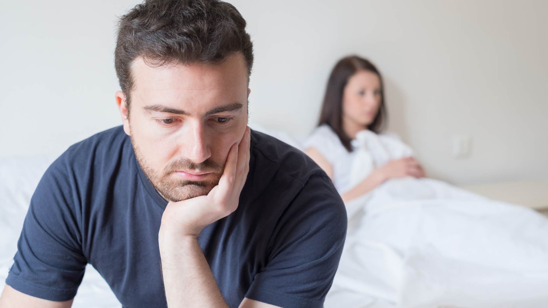 upset man turned away from his wife thinking I miss the way we used to be